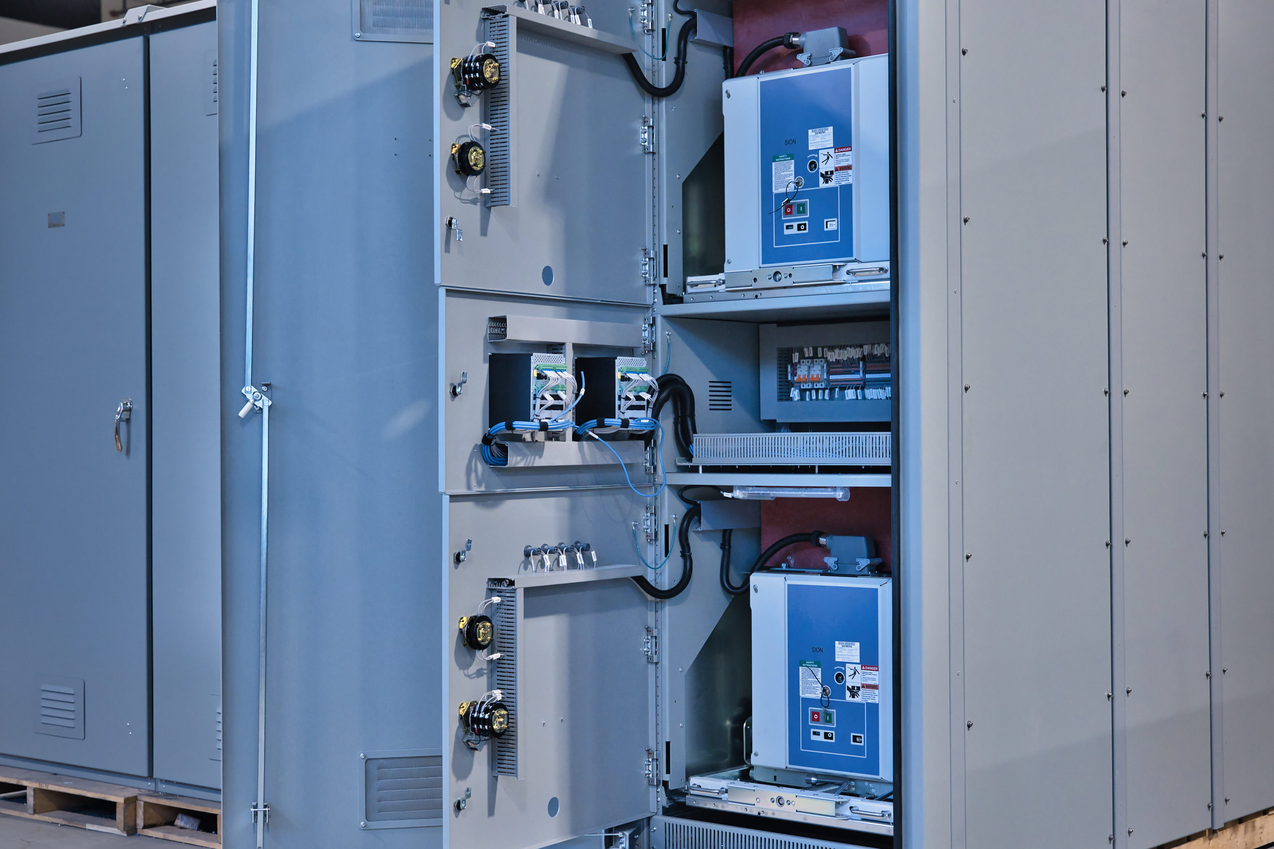 Hydroelectric switchgear showing two withdrawable circuit breakers and internal control wiring.